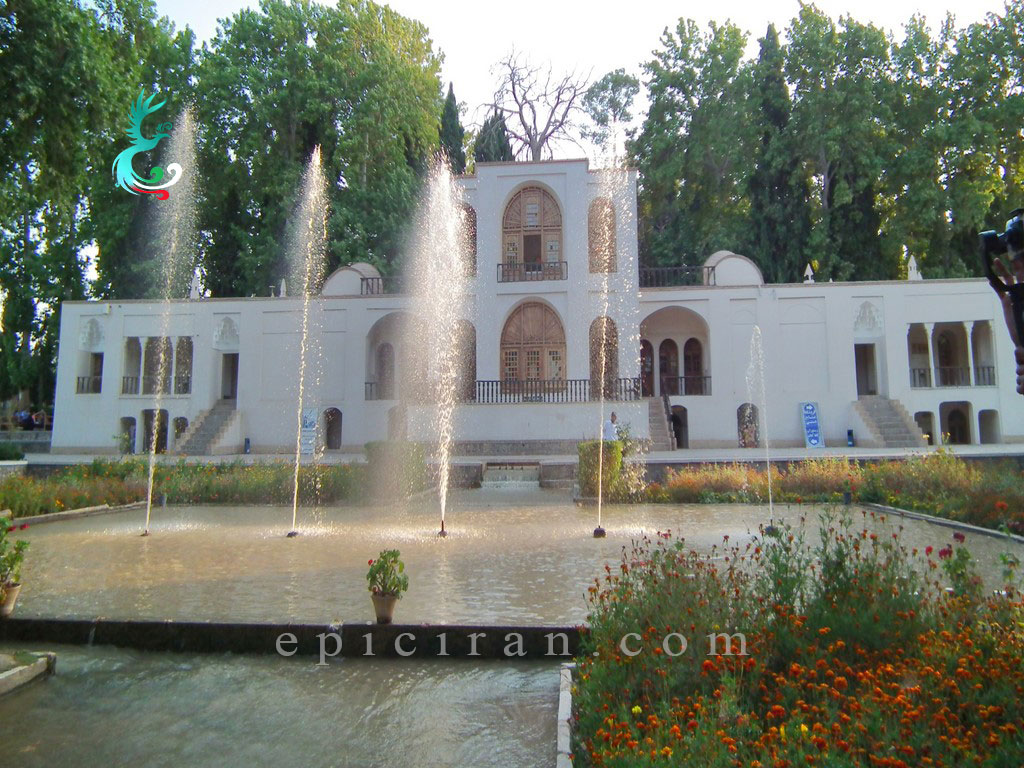 fountain full of water in front of central mansion in shazdeh garden in mahan