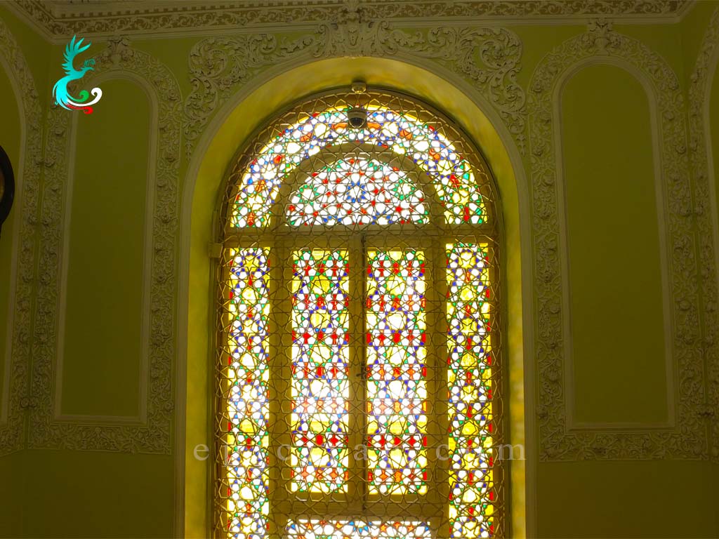 colorful window next to a clock in Time museum in tehran
