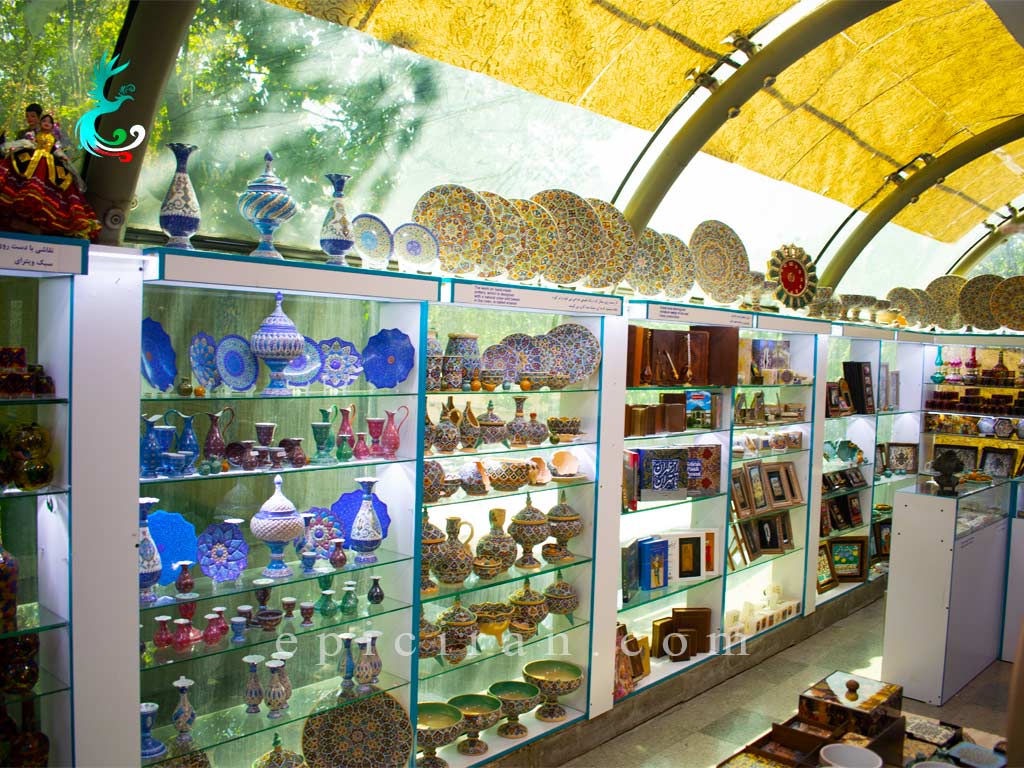 colorful handmades in showcases on a shop in the arrival gate of niavaran palace complex