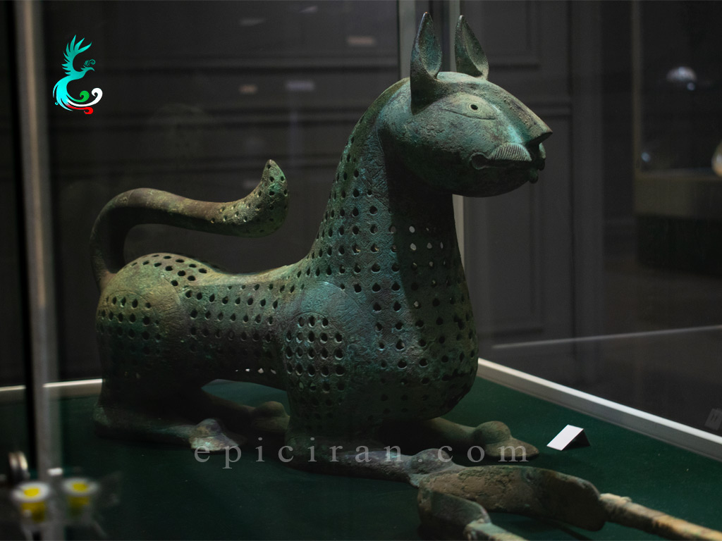 gray ancient objects shaped like panther in showcase in reza abbasi museum in tehran