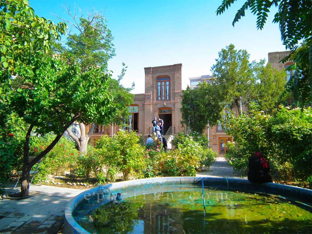 beautiful yard of parvin etesami's house include a pond and some trees