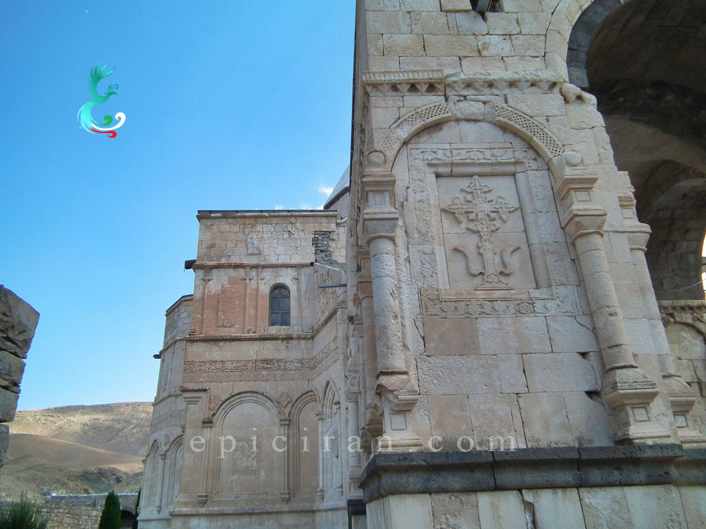 cross-shaped carved stone in white side of saint Thaddeus church in iran