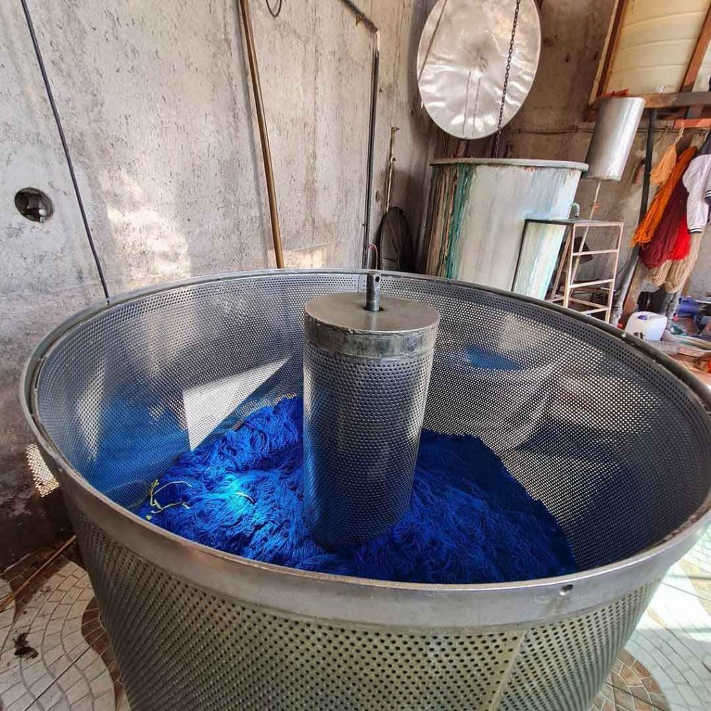 some blue threads in color maker machine used for weaving persian carpets