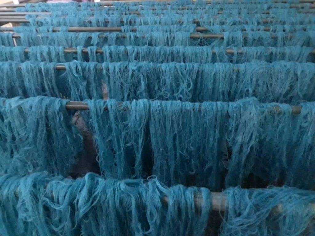 bunch of blue threads used for weaving blue persian carpets