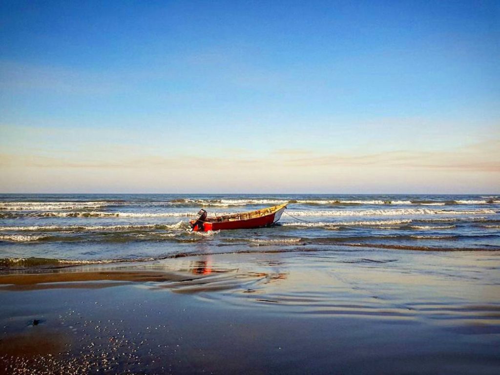 lonely fishing boat in chapakrud beach in iran