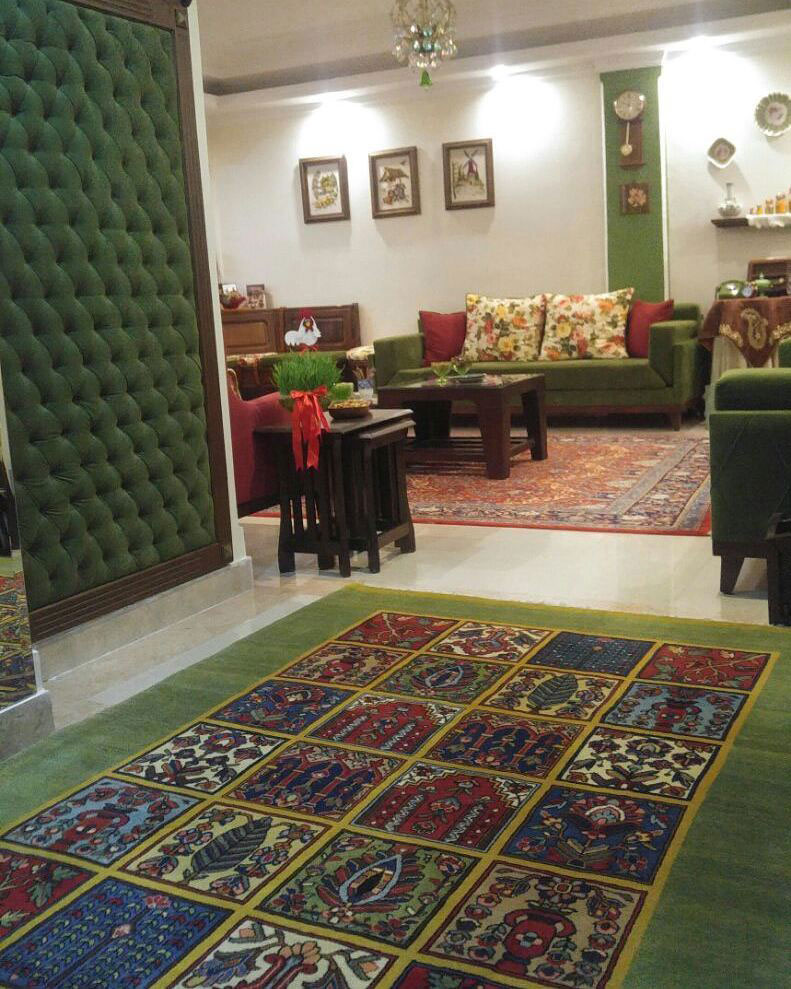 persian green rug in a living room arranged by green furnitures